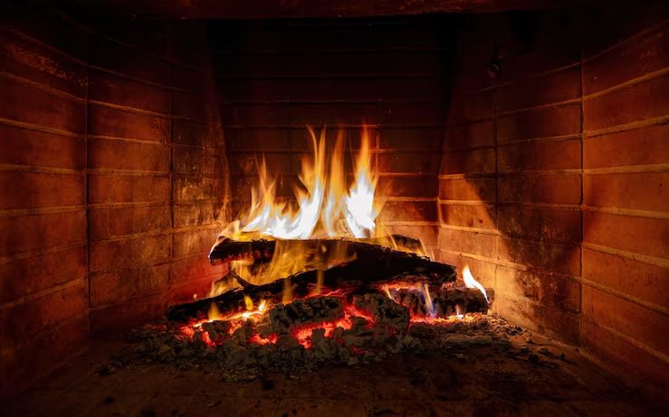 Full blaze drawing cleanly in a brick-lined firebox